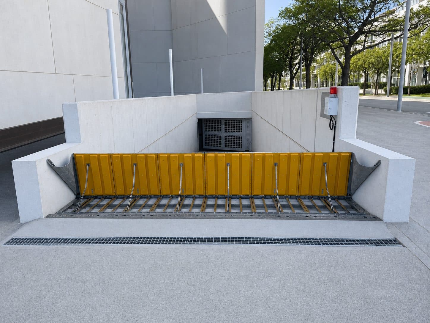 Hydrodynamic passive flood barrier set flush across a basement car park entry