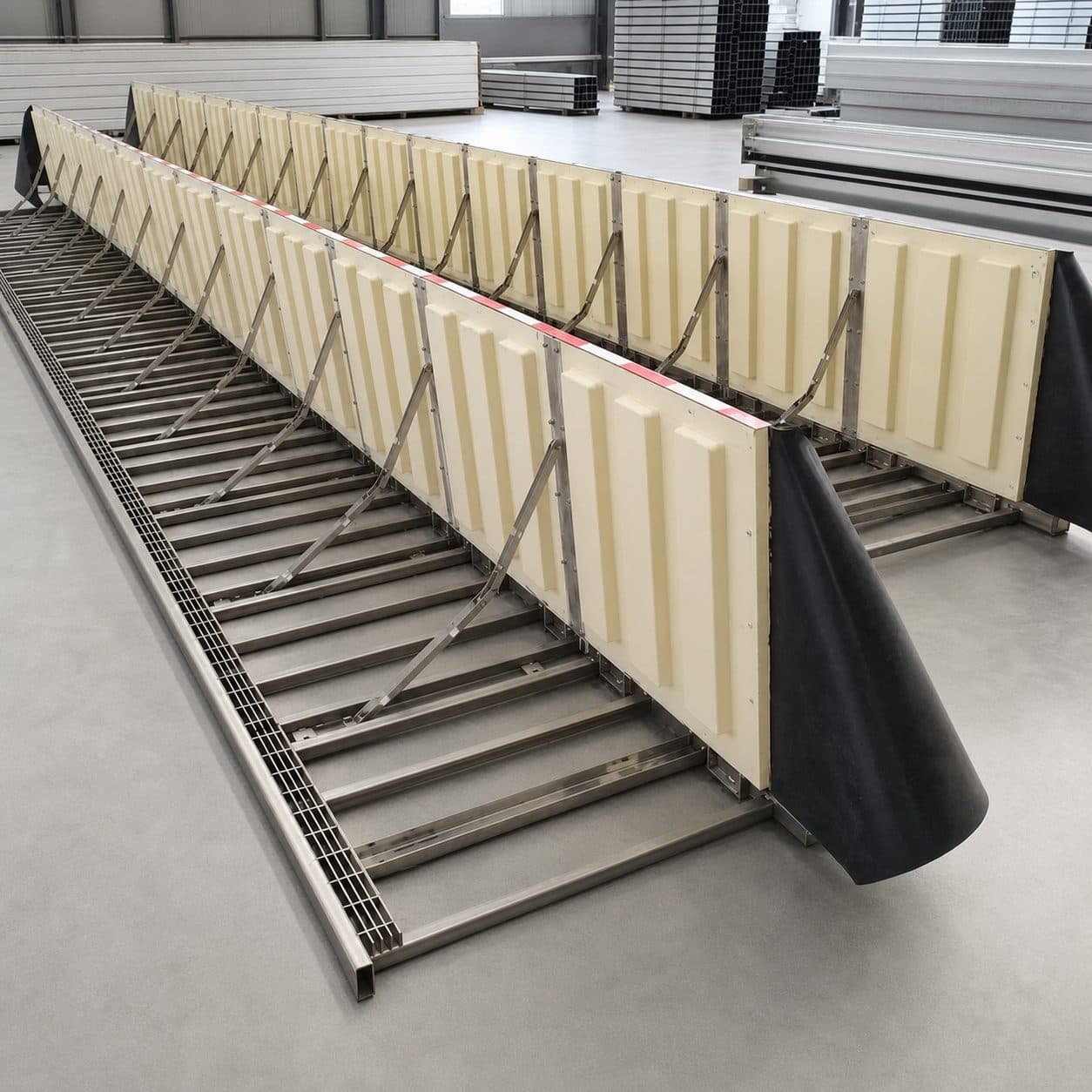 Hydrodynamic passive flood barrier raised across an industrial vehicle gate